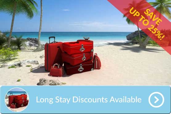 beach scene with a lot of suitcases piled up all ready for a long stay in phuket with a flash advertising dup to 25% discounts at villa oriole