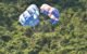 parasails against a jungle backdrop on the phuket coast