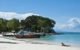 a row of thai long tail boats moored at a sandy beach on phi phi island zeavola hotel with a sexy girl lying in the surf free stock photo