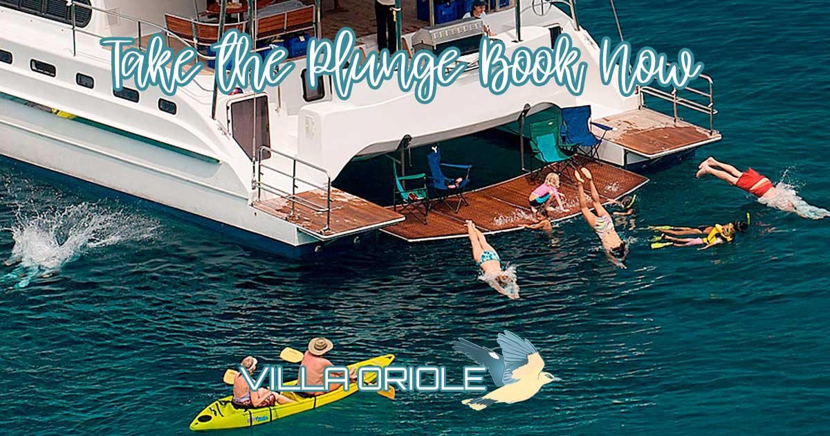holidaymakers diving from the swimdeck of our luxury catamaran into the clear waters of the andaman sea